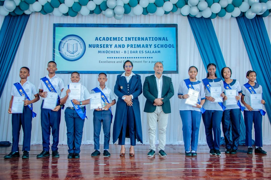 Prof. Lwoga presenting certificates to Class 7 graduates